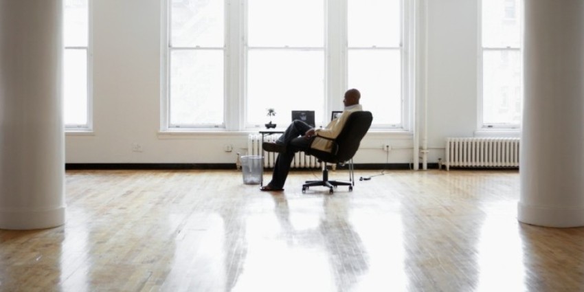 Man sitting at desk in empty office